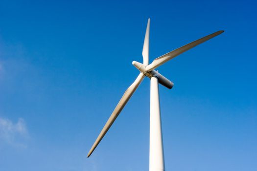 Wind turbine against blue sky