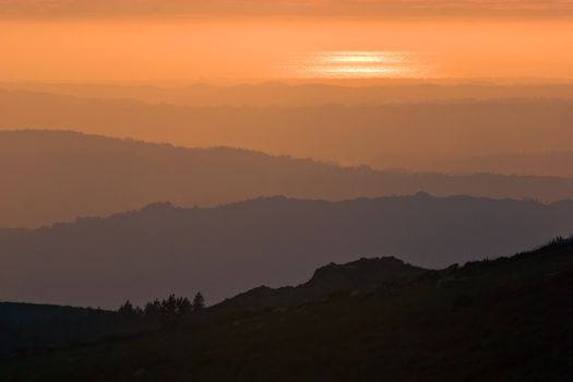 View over layered mountains on a beautiful Sunset. 