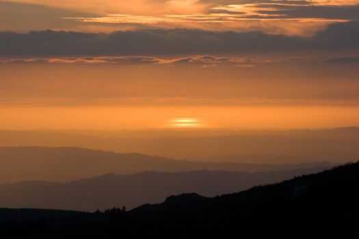 View over layered mountains on a beautiful Sunset. 