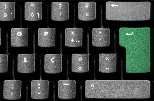 Black keyboard detail with green enter key