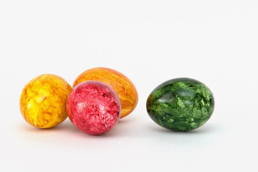 Colored eggs on white background