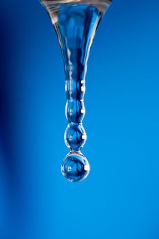 Water dropping on blue background