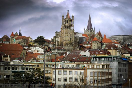 Landscape image of Lausanne showing steeples with a dramatic sky.