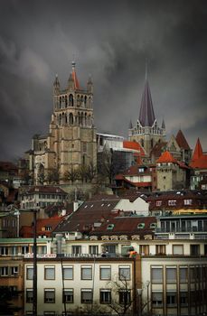 Portrait image of Lausanne showing steeples with a dramatic sky.