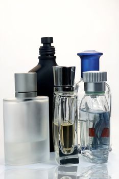 Mens Fragrances and perfumeries over white background with reflection