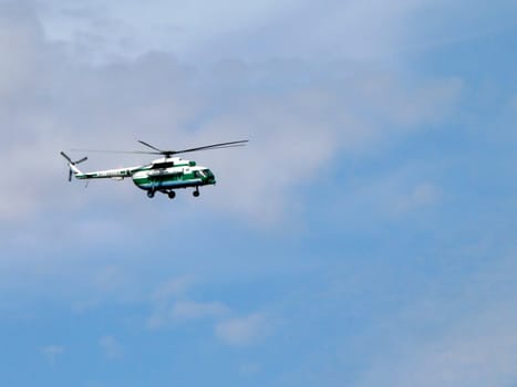 Flying helicopter on blue sky background (chopper)