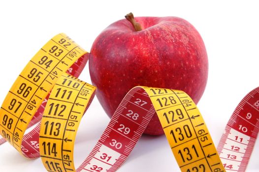 apple and measuring tape isolated on white background