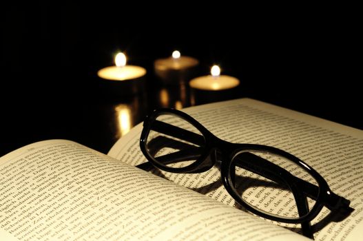 book candle and glasses with black copyspace