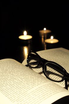 book candle and glasses with black copyspace