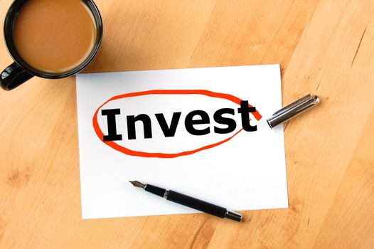 investment business concept with pen paper and cup of coffee
