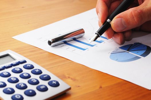 hand and paperwork with business information and pen