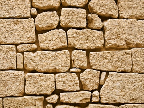 Detail and texture of medieval buildings. Limestone wall in Malta.