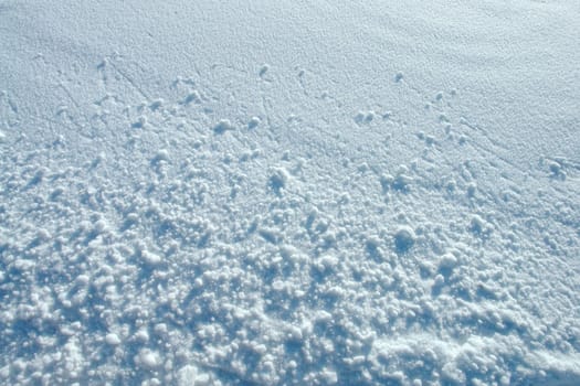 Small snowballs on a plain snow surface