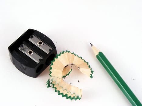 Red, green and blue pencils and a hand sharpener.