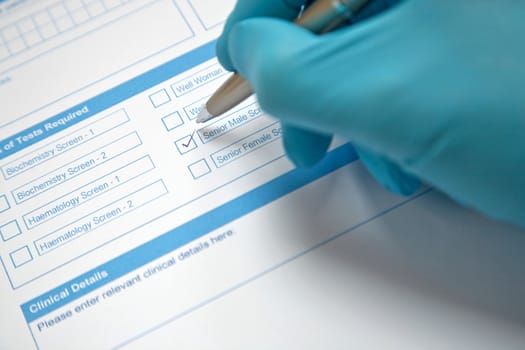 Doctor filling in a blood test form
