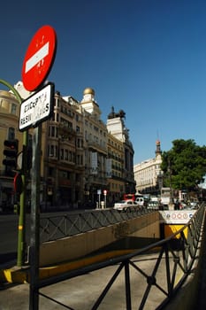 traffic sign in madrid, historical  building and underground