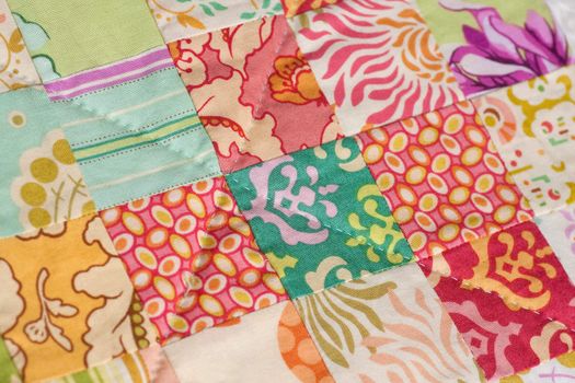 Detail from a handmade patchwork quilt made with squares.