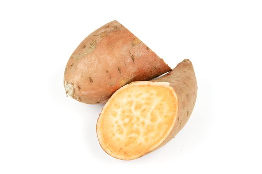 Sweet Potato cut in half on a reflective white background