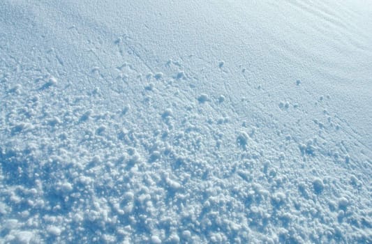 Small snowballs on a plain snow surface