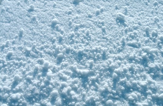 Small snowballs on a plain snow surface