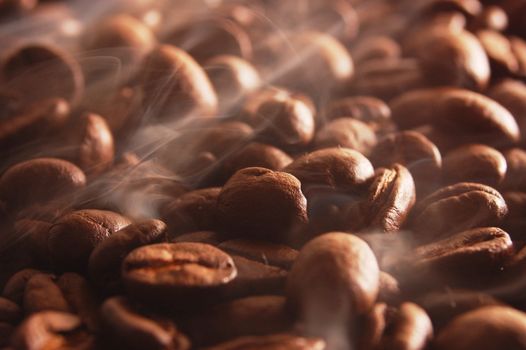 roasting coffee beans with smoke and steam