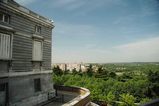 view on border of madrid from madrid palace with trees and blue sky