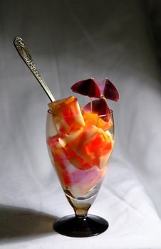 A glass with colourfull jelly in it