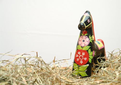      Black	Hohloma horse      standing in hay, on a white background                     