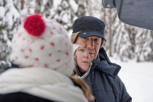 Companion portrait of happy middle-aged couple on a winter day 
