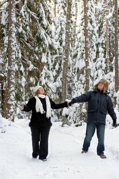 Happy middle-aged couple walking on a winter day 
