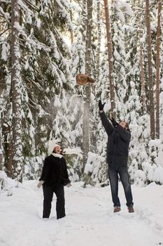 Happy middle-aged couple jumping on a winter day 
