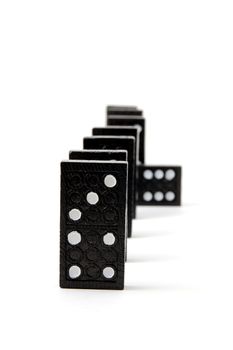 row of dominoes including a special domino stone isolated on white background