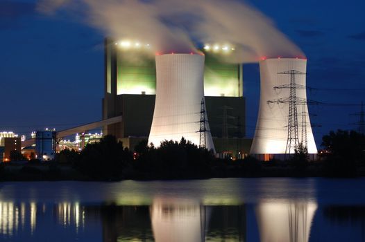 a smoking industrial power plant at night