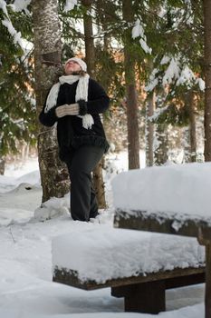 Happy middle-aged women having fun on winters day in forest.