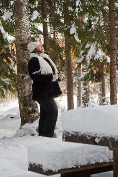 Happy middle-aged women having fun on winters day in forest.