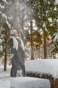 Happy middle-aged women having fun on winters day in forest.