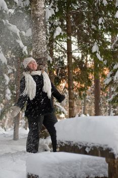 Happy middle-aged women having fun on winters day in forest.