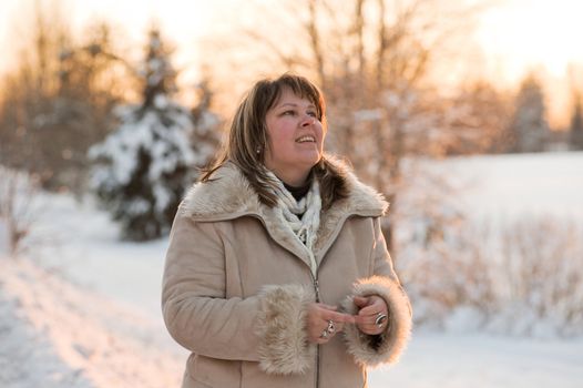 Happy middle-aged women having fun on winters sunset.