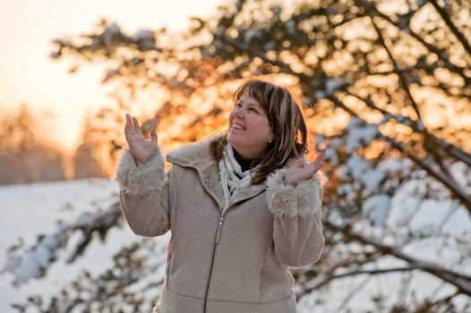 Happy middle-aged women having fun on winters sunset.