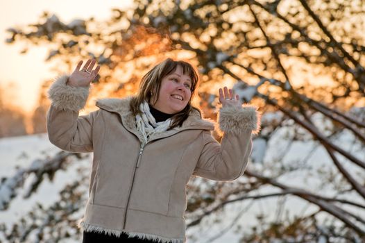 Happy middle-aged women having fun on winters sunset.