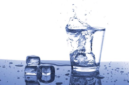 glass of ice water with bubbles on white background