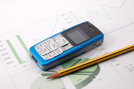 blue cell phone over business chart showing success