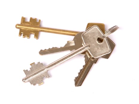 A bunch of keys isolated against a white background.                               