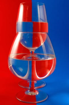 Two glasses on a blue-red background.                               