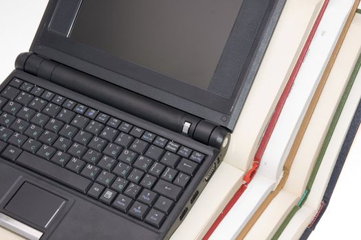 modern laptop with colorful books