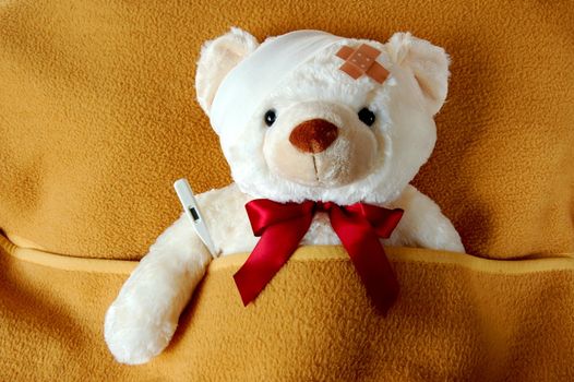 ill teddy bear in bed waiting for medicine