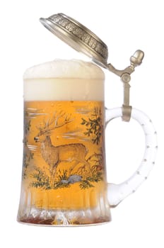 Souvenir glass with the image of the wild nature, filled by beer, with the slightly opened cover