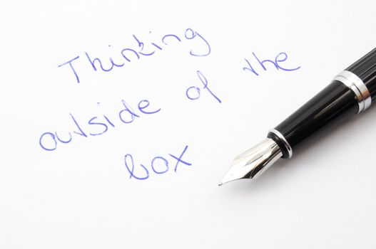 think outside of the box concept with pen and paper