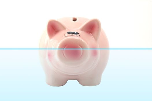piggy bank is swimmin in water showing financial concept