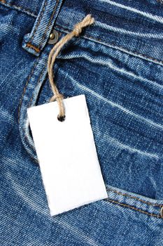 blank price tag with copyspace on a jeans texture